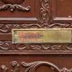 Detail of 'temple open/temple closed' sign on entrance door. 