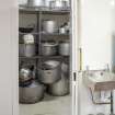 Basement. Kitchen. View of pot cupboard. 