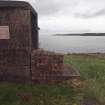 East Gun Emplacement: View from the SW of the brick wall flanking the SE entrance 