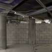 Basement. View showing concrete blockwork, pillars and compartment ceiling.