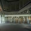 Ground floor.  Reception.  View of reception, showing revolving doors to lobby, concrete compartment ceiling and first floor office space.