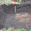 Evaluation photograph, Trench 4 with ranging rod beside N side of feature 4, Proposed play area, Brodie Castle, Moray