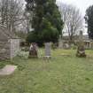 General view across burial ground with mort house, from West