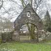 View of arched gateway, with kissing gate to left, from North.