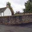 View from north-west showing No 33 High Street, Clackmannan, behind boundary wall