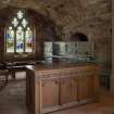 Detail of communion table and stained-glass window in chancel vault