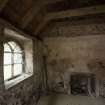 View of Session House interior showing window looking onto graveyard and fireplace. 