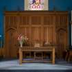 View of platform including communion table, elder's chairs, carved reredos screen, pulpit and organ