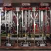 Interior. Racking area, ground floor. View of cask fillers Heads 1-3. Gravity fed from Conditioning Tanks on upper floor.