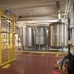 Interior. Racking and Conditioning area, 1st floor. View of Conditioning Tanks prior to racking by gravity to the cask filling area on ground floor.