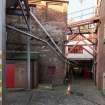 View from south east looking towards access to Brewhouse (left) and Racking (right). The two pipes brought spent grain from Mash Tuns to bins for collection by truck (extreme left).