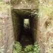 View of brick-lined personnel entrance to WW2 Nissen Hut magazine W30 area, through the reused WW1 blast mound 