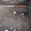 Excavation photograph, TP84 gravel subsoil with shallow depression in natural - possible feature, Nethermills, Crathes, Aberdeenshire