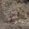 Evaluation photograph, Red granite blocks in demolition rubble layer, Grieve's House, Aden Country Park, Mintlaw, Peterhead