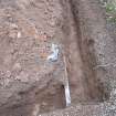 Watching Brief photograph, Trench showing ceramic water pipe at base of trench and blue modern water pipe 0.4m down, Knock Hill House, Glenbervie, Aberdeenshire