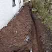 Watching Brief photograph, Trench showing ceramic water pipe at base of trench and blue modern water pipe 0.4m down, Knock Hill House, Glenbervie, Aberdeenshire