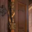 Careston Parish Church.  Porch.  Detail of brass hinge on interior entrance door.