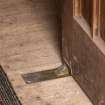 Careston Parish Church.  Porch.  Detail of brass doorstop on interior entrance door.