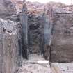 Excavation photograph, S corner of  Trough 011 showing substance on timbers, 396-410 Gorgie Road, Edinburgh