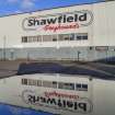 Detail of Shawfield Greyhounds sign on west face of the stadium with reflection in puddle.