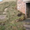 View from the S of the steps leading down the cliff to the searchlight emplacement, with the entrance to the porch (right) 