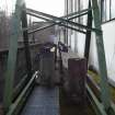 Carsfad Hydro Electric Power Station, Turbine House. View of stop log area and gantry above tailrace outlet of turbine house from north east