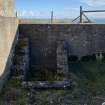 View from the NW of the steps leading up to the NE wing wall of the gun platform in the NE emplacement 