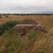 Explosives Magazine R59: the deflation of the blast mound adjacent to the brick revetment situated at the W end of the building ESE of the narrow gauge railway cutting