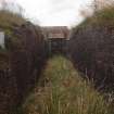 W15: view from the NNW through the brick revetment that formed the sides of the original tunnel through the WW1 blast wall to the entrance at the WSW end of the later ammunition magazine