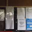 Interior, W3: a selection of notices attached to the NNW wall adjacent to the ammunition store’s entrance