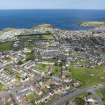 Oblique aerial view from south-west showing Mid- to Late C20 (Deanhead), Mid- to Late C20 (Barefoots), Recreation (Holiday Park) and Inter-War (Hurkur Crescent and Schools) Areas of Townscape Character, Eyemouth