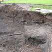 Excavation photograph, Initial machining next to manhole concrete foundations and metal pipe, Paisley Abbey, Renfrewshire