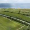 Oblique aerial view from south-west showing Recreation (Golf Course) and area for proposed development in Modern (Gunsgreenhill) Areas of Townscape Character, Eyemouth