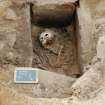 Excavation photograph, Detail of skeleton and cist taken from N, Keas Cottage, Spinningdale, Highlands