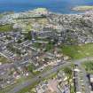 Oblique aerial view from south-west showing Modern (Acredale), Mid- to Late C20 (Deanhead), Mid- to Late C20 (Barefoots), Inter-War (Hurkur Crescent and Schools) and Recreation (Holiday Park) Areas of Townscape Character, Eyemouth