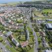 Oblique aerial view from west-north-west showing Inter-War (Hurkur Crescent and Schools) and Industrial (Acredale and Eyemouth Industrial Estates) Areas of Townscape Character, Eyemouth