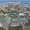 Oblique aerial view from south-south-west showing Industrial (Acredale and Eyemouth Industrial Estates) and Inter-War (Hurkur Crescent and Schools) Areas of Townscape Character, Eyemouth