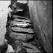 Excavation photographs - paving in chamber and passage, from the north-west.