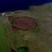 Oblique aerial view of the Ring of Brodgar, henge and stone circle, taken from the W.  Also visible are cairns and the 'Comet Stone'