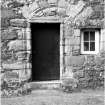 Detail of NE doorway with remains of arch above.