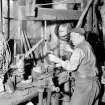 Mr D McCallum working the beam hand-drill at Machrimore Smithy, Kintyre, in 1962.