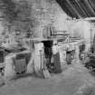 Redhouses Woolen Mill, Islay.
Dye-room, showing on South wall (left to right) electric dyeing-vat, soap boiler, press-plate oven, copper dyeing-vat (with reeling frame over) and cast-iron dyeing vat. In right foreground are washing-tubs with manual plunger and two dripping frames (scrays) for drip-drying the hanks.