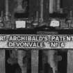 Redhouses Woolen Mill, Islay.
Detail of maker's name-plate on piecing machine - 'Rt. Archibald's patent Devonvale. No.6'.