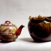 View of Dunmore ware teapot and scallop-edged vase.