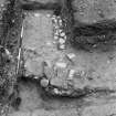 Excavation photograph of the E gate with an inverted gutter and possible foundations of the guard chamber.
