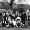 Gardeners at 'The Glen' Country House near Innerleithen, seated and standing in gardens, holding watering cans, shears, rakes and other gardening implements.