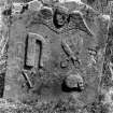 Kilbrannan Chapel, Kaymand Tombstone.
Detail of Kaymand tombstone in churchyard, dated 1727 and with tailors' insignia, including an iron and scissors.