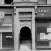 View of the main entrance on the South facade of the 'Grecian Building' at No. 336 - 356 Sauchiehall Street, Glasgow. Above the doorway is insc. '346. Stage Furnishings Ltd.'