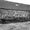 Detail of blocked openings and projecting boulders on N side of steading from NE