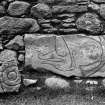 View of two fragments of Pictish symbol stones (Clatt nos.2 and 3).
Original negative captioned: 'Sculptured Stone in West Wall of Clatt Churchyard Sep 1905 Size of stone 34 x 15 inches also fragment of sculptured stone formerly discovered by Mr. Macdonald in churchyard'.